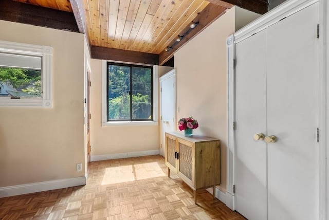 doorway to outside featuring baseboards and wood ceiling