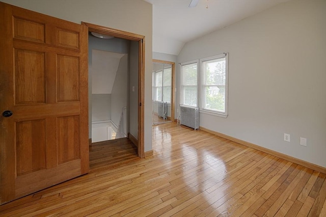 65 Cedar St, Weymouth, MA 02189 - unfurnished bedroom with radiator, lofted ceiling, light wood-style floors, and baseboards