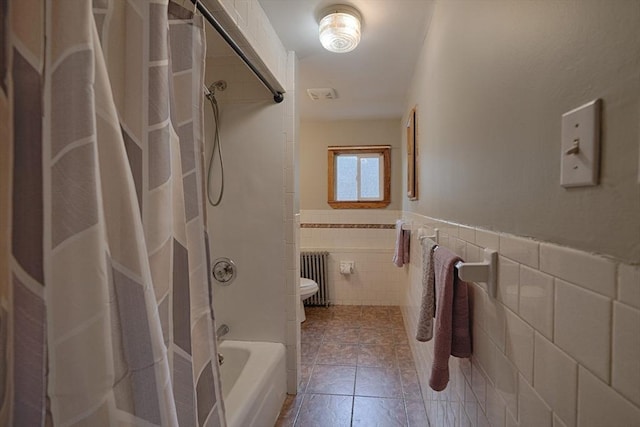 65 Cedar St, Weymouth, MA 02189 - bathroom with radiator heating unit, tile walls, toilet, shower / tub combo with curtain, and a wainscoted wall