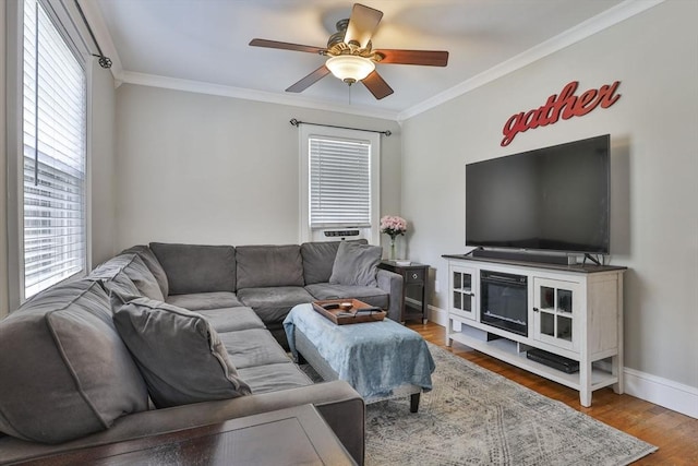 10 Hemenway St, Methuen, MA 01844 - living area featuring ornamental molding, baseboards, a ceiling fan, and wood finished floors