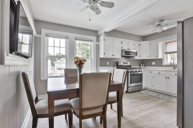 10 Hemenway St, Methuen, MA 01844 - kitchen featuring stainless steel appliances, a ceiling fan, plenty of natural light, and beamed ceiling