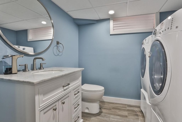 10 Hemenway St, Methuen, MA 01844 - bathroom with a drop ceiling, washing machine and clothes dryer, vanity, toilet, and wood finished floors