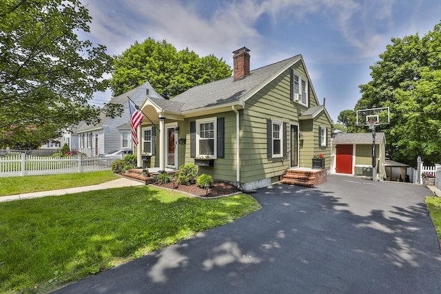 10 Hemenway St, Methuen, MA 01844 - view of front of house with a chimney, an outbuilding, and roof with shingles