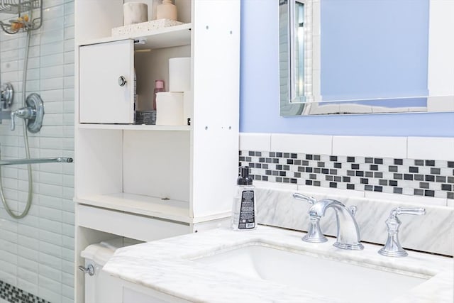 bathroom with vanity and a tile shower