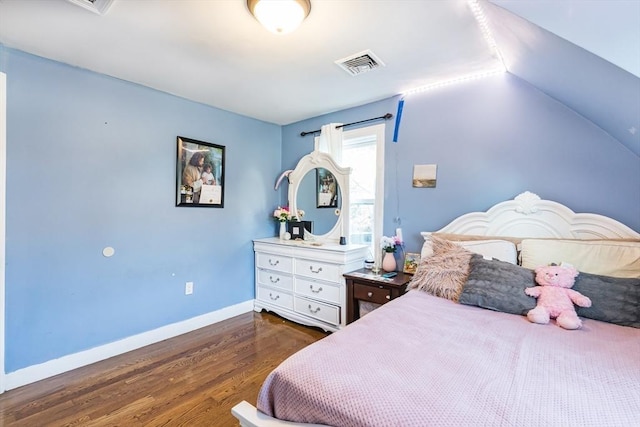 bedroom featuring lofted ceiling and dark hardwood / wood-style floors