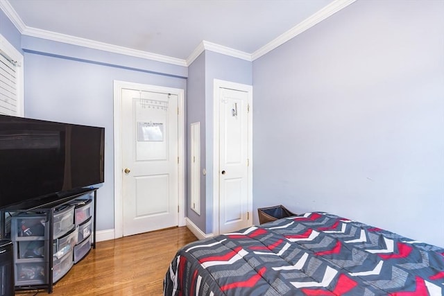 bedroom featuring hardwood / wood-style flooring and crown molding