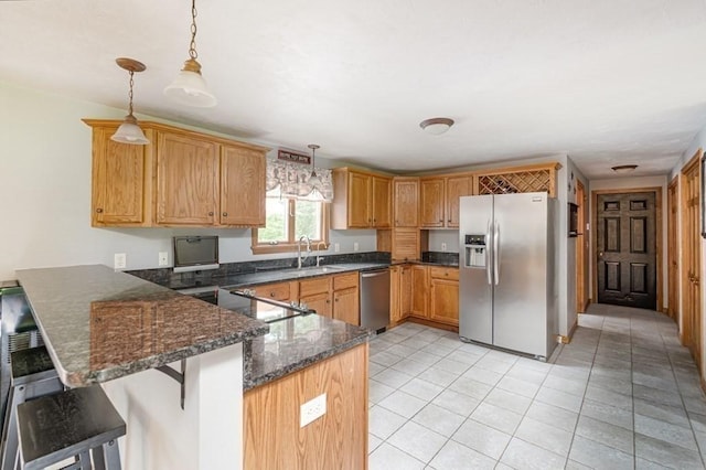 10 Tobin Dr, Dudley, MA 01571 - kitchen featuring stainless steel appliances, a peninsula, decorative light fixtures, dark stone countertops, and a breakfast bar area
