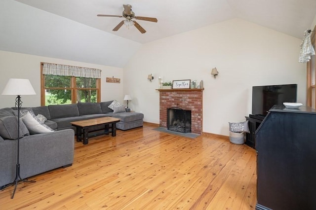 10 Tobin Dr, Dudley, MA 01571 - living area with vaulted ceiling, a ceiling fan, light wood-type flooring, and a brick fireplace