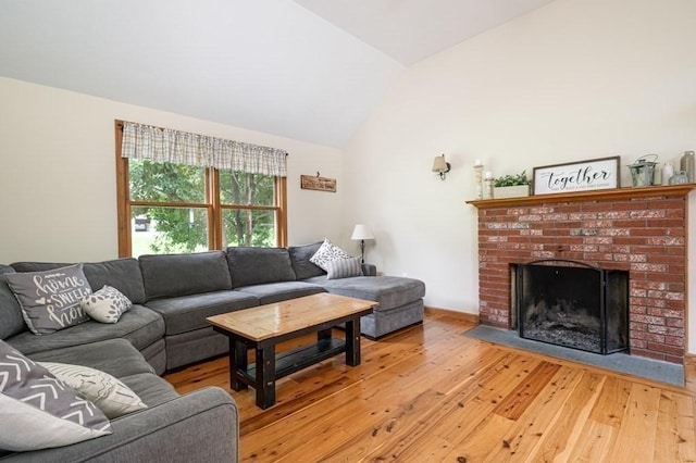 10 Tobin Dr, Dudley, MA 01571 - living area featuring wood-type flooring, vaulted ceiling, and a brick fireplace