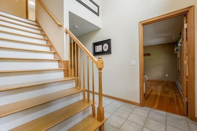 10 Tobin Dr, Dudley, MA 01571 - stairs with a baseboard heating unit and tile patterned floors