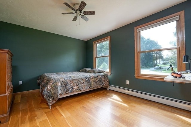 10 Tobin Dr, Dudley, MA 01571 - bedroom featuring baseboard heating, light wood-style flooring, and a ceiling fan