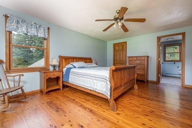 10 Tobin Dr, Dudley, MA 01571 - bedroom with light wood-style floors, a baseboard radiator, ensuite bath, and ceiling fan