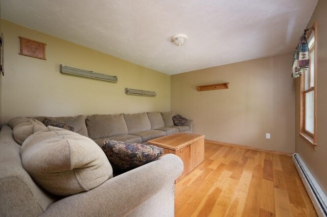 10 Tobin Dr, Dudley, MA 01571 - living area with a baseboard radiator and light wood finished floors