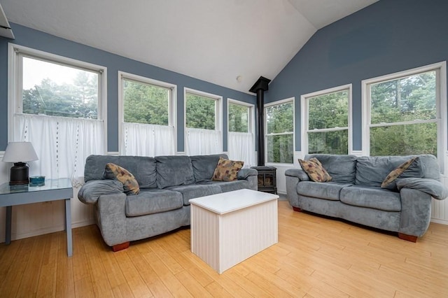 10 Tobin Dr, Dudley, MA 01571 - living area with a wood stove, healthy amount of natural light, light wood-type flooring, and vaulted ceiling