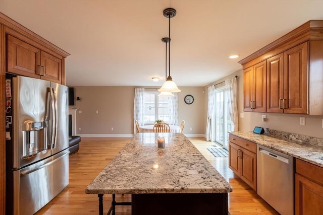 225 Salem Rd, Dracut, MA 01826 - kitchen with stainless steel appliances, a kitchen island, light wood finished floors, brown cabinetry, and recessed lighting