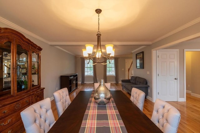 225 Salem Rd, Dracut, MA 01826 - dining room with a chandelier, light wood finished floors, ornamental molding, and baseboards