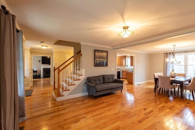 225 Salem Rd, Dracut, MA 01826 - living room featuring stairway, light wood-style floors, crown molding, baseboards, and a fireplace