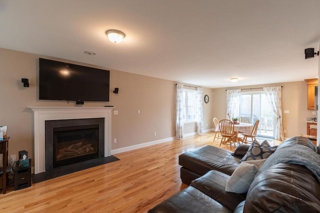 225 Salem Rd, Dracut, MA 01826 - living room with light wood-style floors, a fireplace with flush hearth, and baseboards