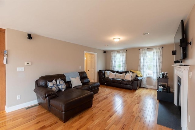 225 Salem Rd, Dracut, MA 01826 - living room with light wood-type flooring, baseboards, and a fireplace