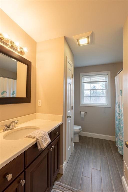 225 Salem Rd, Dracut, MA 01826 - bathroom featuring toilet, vanity, wood finished floors, and baseboards
