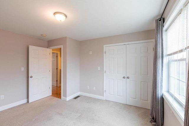 225 Salem Rd, Dracut, MA 01826 - unfurnished bedroom with light carpet, baseboards, and a closet