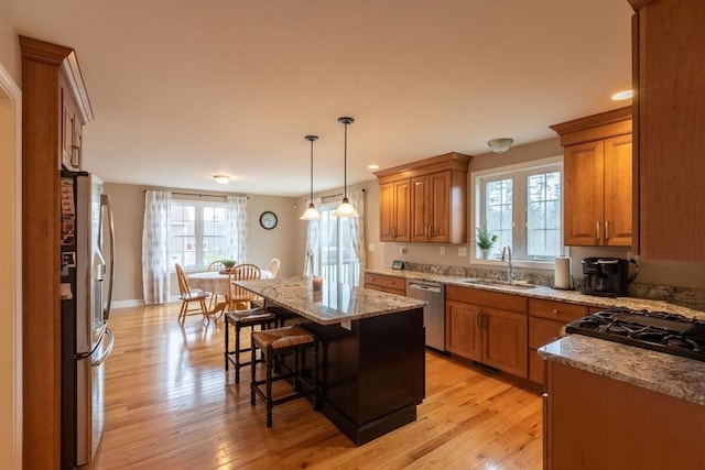 225 Salem Rd, Dracut, MA 01826 - kitchen featuring appliances with stainless steel finishes, a sink, brown cabinetry, plenty of natural light, and recessed lighting