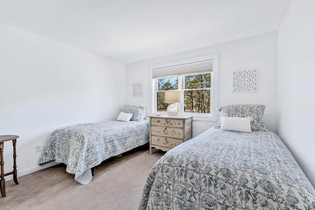 carpeted bedroom featuring baseboards