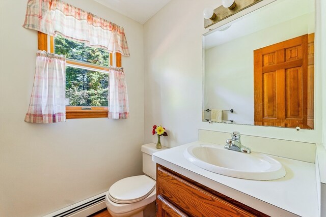 bathroom featuring a baseboard radiator, vanity, and toilet