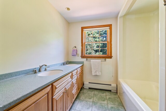 bathroom featuring vanity, a baseboard radiator, a tub to relax in, and tile patterned flooring