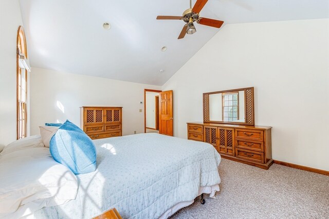 carpeted bedroom featuring ceiling fan and high vaulted ceiling