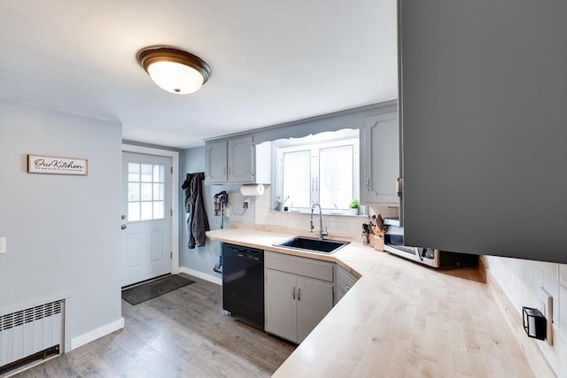 719 College Hwy, Southwick, MA 01077 - kitchen featuring radiator, a sink, black dishwasher, tasteful backsplash, and light countertops