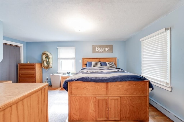 719 College Hwy, Southwick, MA 01077 - bedroom featuring a baseboard radiator and light wood finished floors