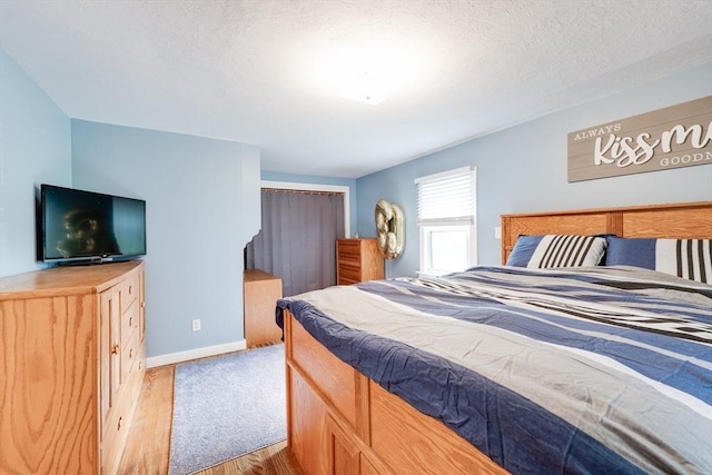 719 College Hwy, Southwick, MA 01077 - bedroom featuring light wood-style floors, baseboards, and a textured ceiling