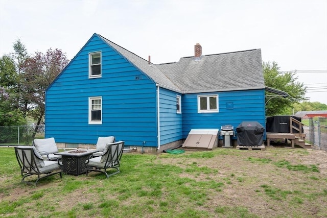 719 College Hwy, Southwick, MA 01077 - back of house with a fire pit, a chimney, and roof with shingles