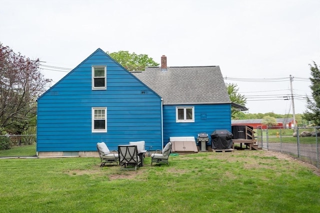 719 College Hwy, Southwick, MA 01077 - back of property with roof with shingles and a chimney