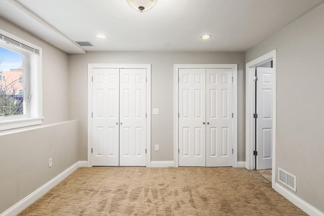 90 Litchfield Unit A, Boston, MA 02135 - unfurnished bedroom featuring multiple closets, light colored carpet, recessed lighting, and baseboards