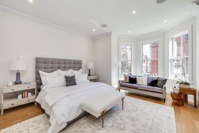 bedroom with light hardwood / wood-style flooring and crown molding