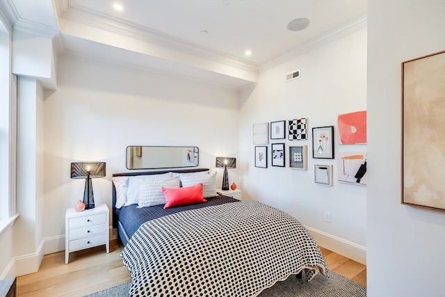 bedroom featuring ornamental molding and light wood-type flooring