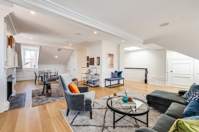 living room featuring crown molding, beam ceiling, and light hardwood / wood-style floors