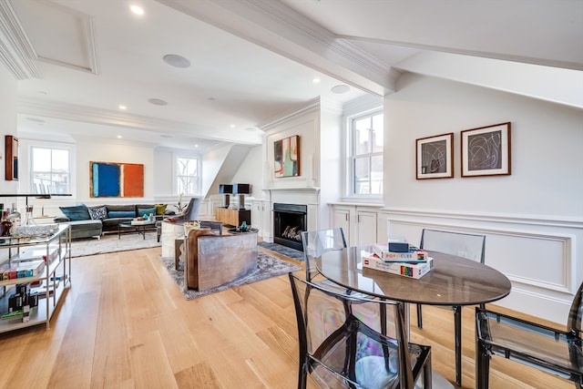 dining area featuring crown molding and light hardwood / wood-style floors