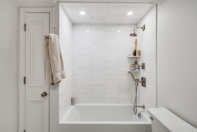 bathroom featuring tiled shower / bath combo and toilet