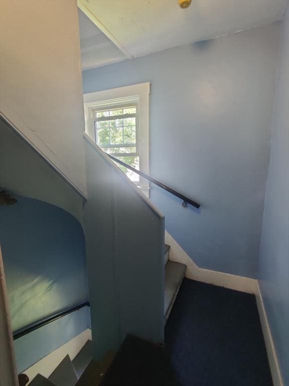 stairway featuring baseboards