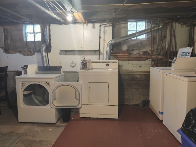 clothes washing area with washer and clothes dryer