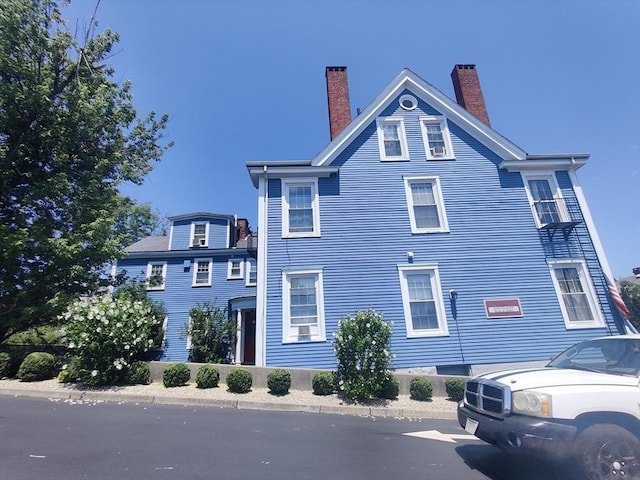 view of property exterior with a chimney