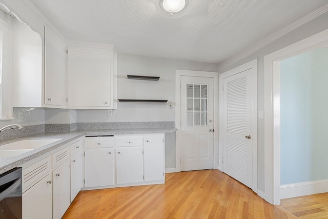 kitchen featuring white cabinetry, light hardwood / wood-style floors, dishwasher, and sink