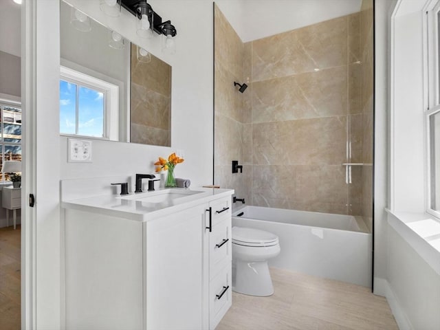 full bathroom featuring vanity, toilet, and tiled shower / bath