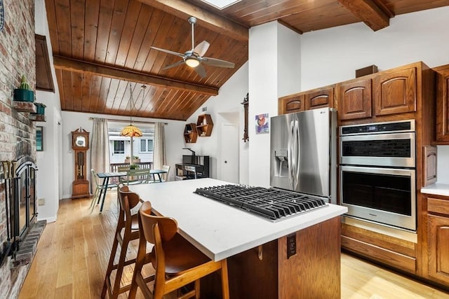 27 Johnson St, Malden, MA 02148 - kitchen with appliances with stainless steel finishes, wooden ceiling, light wood-type flooring, a center island, and a fireplace