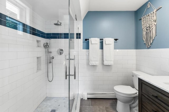 27 Johnson St, Malden, MA 02148 - bathroom featuring a baseboard radiator, a shower stall, tile walls, vanity, and tile patterned flooring