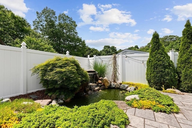 27 Johnson St, Malden, MA 02148 - fenced backyard featuring a garden pond