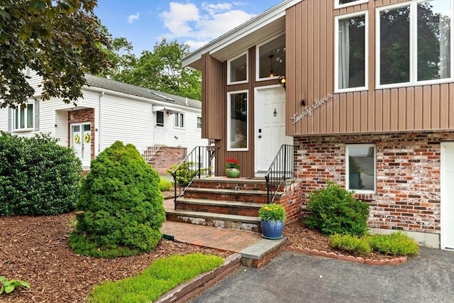 27 Johnson St, Malden, MA 02148 - property entrance with board and batten siding and brick siding